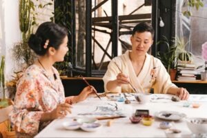 Charlene and Anil, a husband-and-wife artist duo from Los Altos, painting together in their studio—a glimpse into the creative partnership that later found a home for their work at Konditorei Café. 