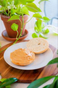 Toasted New York-style bagel spread with creamy peanut butter from Konditorei Cafe. 